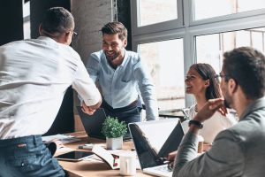 Office workers shaking hands in a meeting